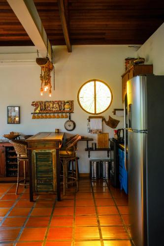 a kitchen with a refrigerator and a table at The Cats' House in Florianópolis