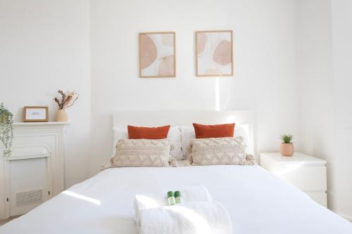 a white bedroom with a large white bed at Hampton House - Sleeps 7 - Free Parking and WiFi in Bristol