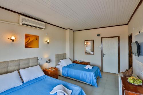 a hotel room with two beds and a television at Club Hotel Gultur in Kucukkuyu