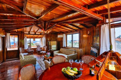 a living room with a table and chairs at Club Hotel Gultur in Kucukkuyu
