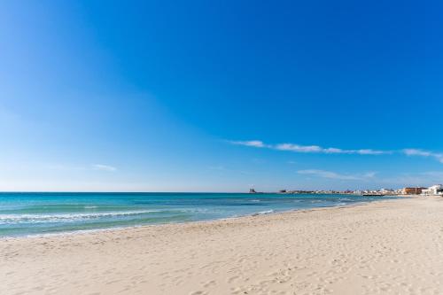 a sandy beach with the ocean in the background at Villetta Lido Canne in Torre Lapillo