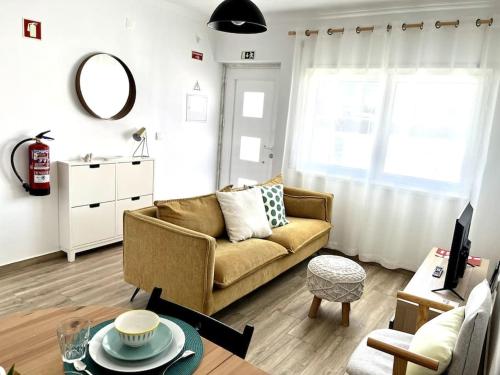 a living room with a couch and a table at Casa da Ana - Country Home in Terrugem