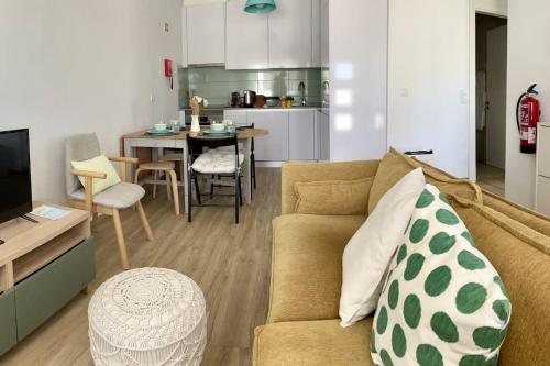 a living room with a couch and a kitchen at Casa da Ana - Country Home in Terrugem