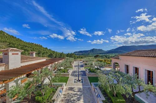 an aerial view of a city with trees and buildings at CAP VERMELL GRAND HOTEL in Canyamel