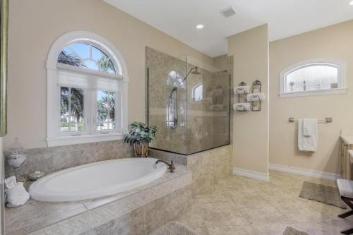 a large bathroom with a tub and a window at Stunning home with pool, spa and huge waterview in Marco Island