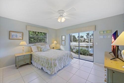 a bedroom with a bed and a view of the ocean at 429 North Barfield Drive in Marco Island