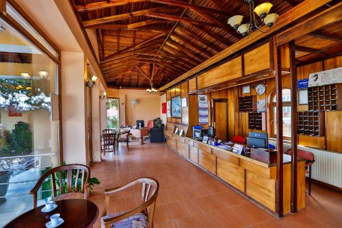 a restaurant with tables and chairs and a bar at Club Hotel Gultur in Kucukkuyu