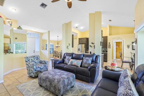 a living room with a leather couch and chairs at Pet-friendly home with pool and steps to beach/food in Marco Island