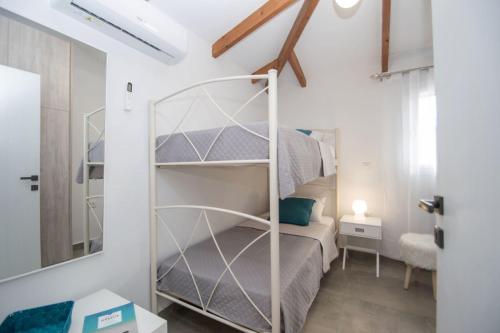 a bedroom with a bunk bed in a room at Green Oak Villa in Orthoniaí