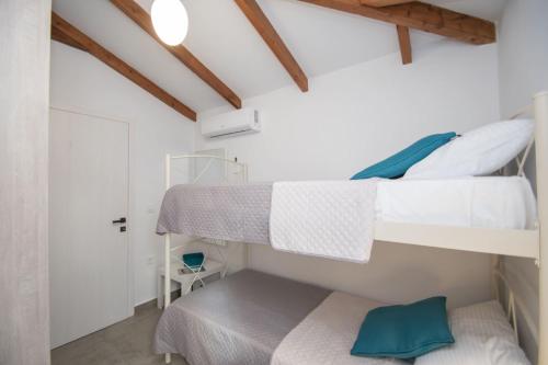 a bedroom with two bunk beds and a door at Green Oak Villa in Orthoniaí