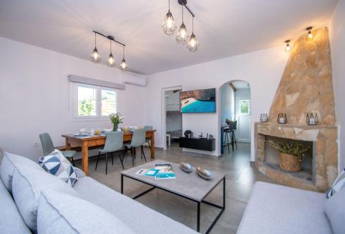 a living room with a couch and a table at Green Oak Villa in Orthoniaí