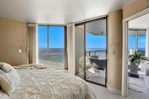 a bedroom with a bed and a view of the ocean at Sandcastle I-1201 in Marco Island