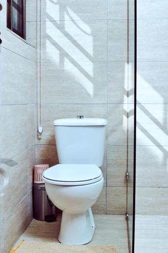 a bathroom with a white toilet in a room at ADA - Granite Court in Accra