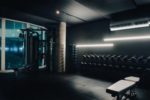 a dark room with a gym with chairs and lights at STAY Nordhavn in Copenhagen