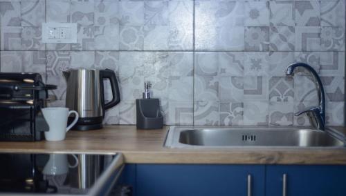 a kitchen counter with a stainless steel sink at Green Oak Villa in Orthoniaí