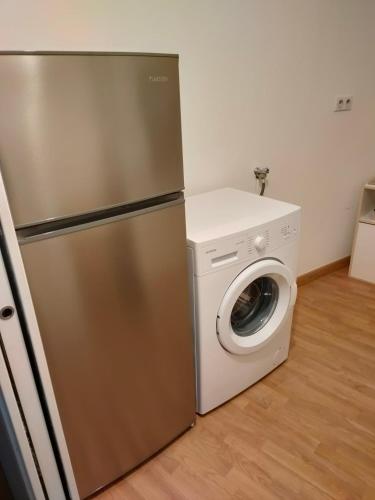 a refrigerator and a washing machine in a kitchen at Luxury Loft Lourdes in Lourdes