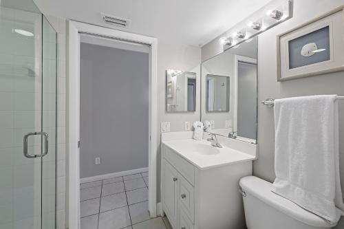 a white bathroom with a sink and a toilet at Beach Club 206 in Marco Island