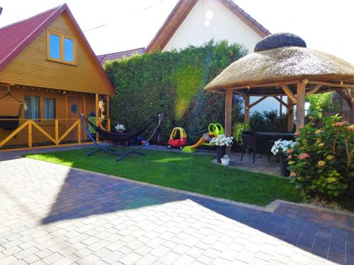 a backyard with a gazebo and a lawn at Domki u Skrzata Drewniane in Łeba