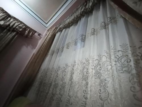 a white shower curtain in a room at Hossam hotil in Jazīrat al ‘Awwāmīyah