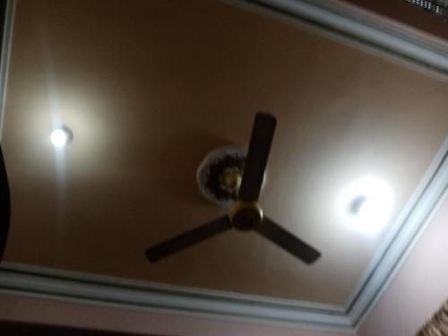 a clock on the ceiling of a room at Hossam hotil in Jazīrat al ‘Awwāmīyah
