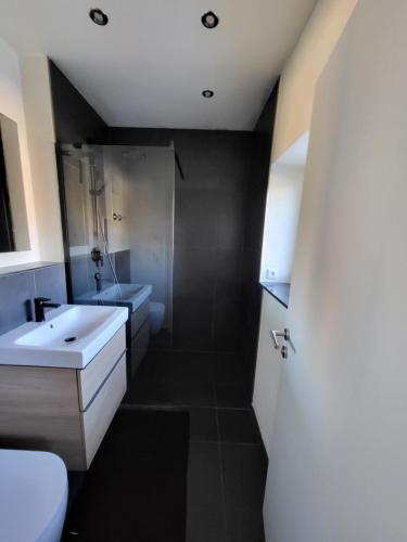 a bathroom with a sink and a shower and a toilet at Quartier4 in Sonthofen