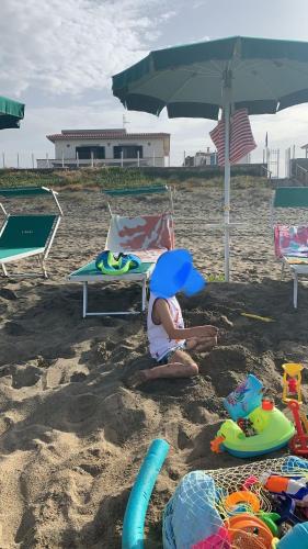 a child playing in the sand on the beach at Edoardo e Franca in Minturno