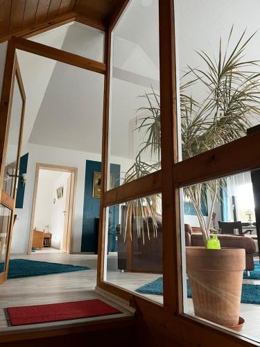 a living room with a window and a potted plant at Wohnung nahe Heidepark & Serengetipark in Bergen