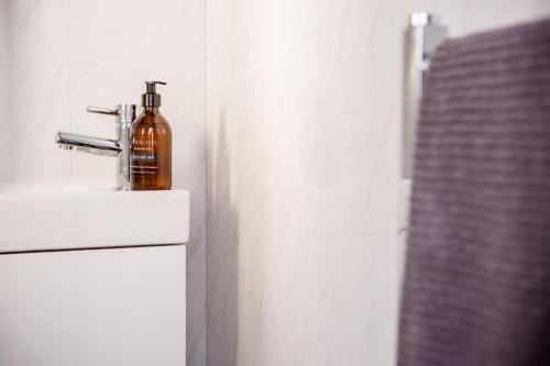 a bottle of alcohol sitting on top of a refrigerator at Wansbeck Riverside Caravan Park in Ashington