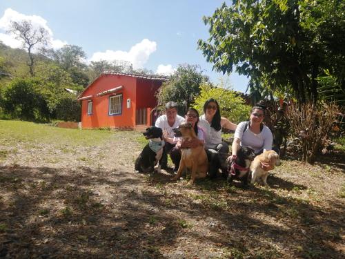 a group of people with their dogs in front of a house at Finca el Paraíso in San Gil