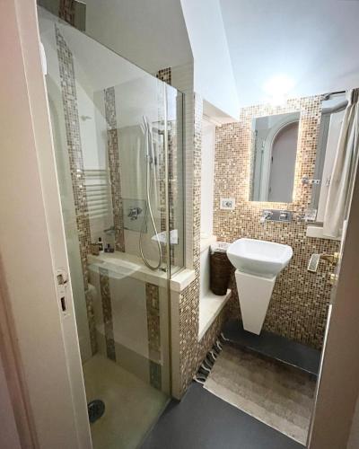 a bathroom with a shower and a toilet and a sink at Suite San Martino in Martina Franca