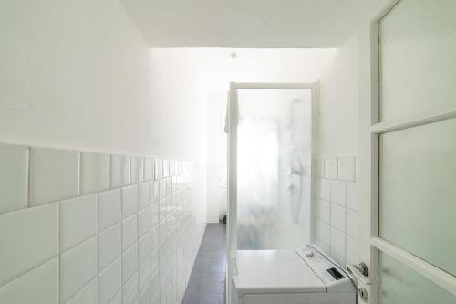 a white bathroom with a sink and a shower at Hbhall Residenze Darsena in Milan