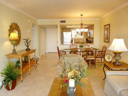 a living room with a couch and a table at Tranquil waterfront condo with pool and steps to beach in Marco Island