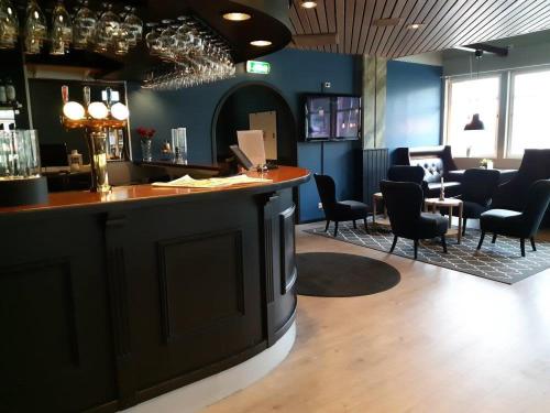 a bar in a restaurant with chairs and a counter at Monicas Bed&Breakfast in Hagfors