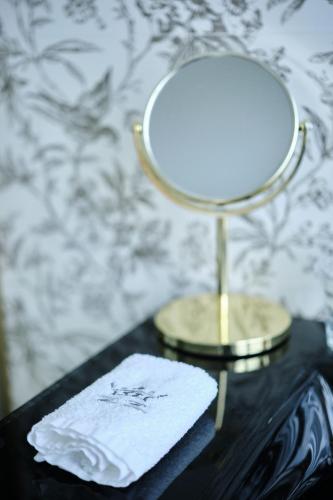 a table with a lamp and a napkin on it at HOTEL BOUTIQUE VILLA DEL MARQUÉS in Muros de Nalón