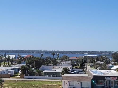 arial view of a city with buildings and a body of water at Beachside Hotel - POOL IS OPEN! in Daytona Beach
