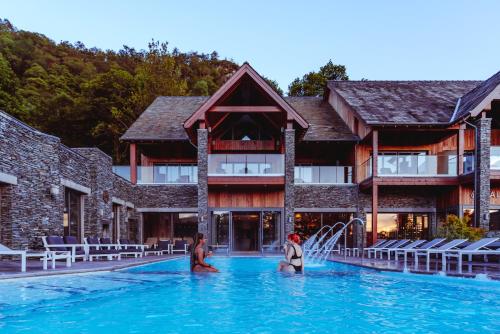 two people in the swimming pool at a resort at Lodore Falls Hotel & Spa in Keswick