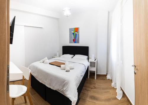 a bedroom with a large bed with white sheets at Suite Apartment Siatista in Siatista