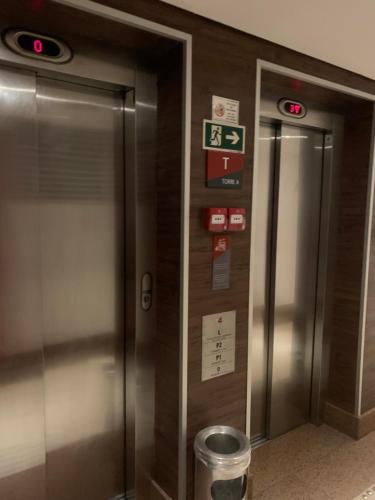an elevator in a building with signs on the wall at FLAT 1417 in Águas Claras