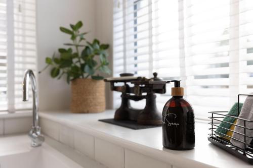 a bottle of soap sitting on a counter next to a sink at The Weights and Measures Office in Berwick-Upon-Tweed