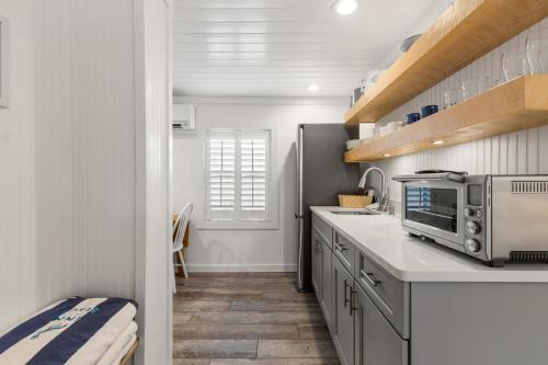 a kitchen with a sink and a microwave at Inn on the Beach in St Pete Beach