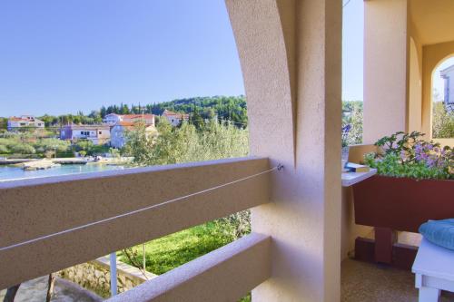 a balcony with a view of a river at Sandy Beach Studio in Lukoran