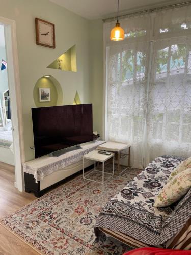 a room with a bed and a table and a window at Evangeline House in Da Lat