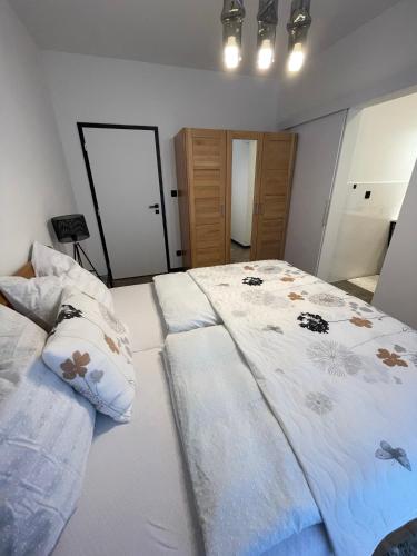 a bedroom with a large bed and two pillows at Chalet Sijkovsky in Stará Lesná