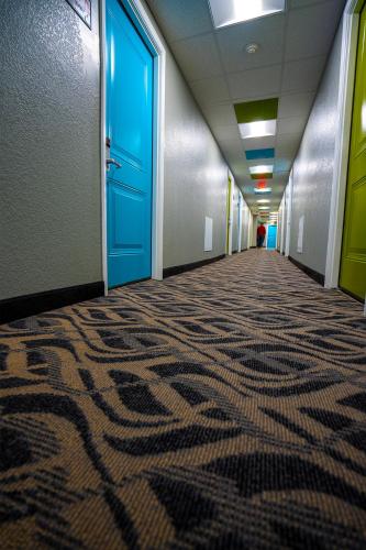an empty hallway with a carpeted floor in an office building at Philly Inn & Suites in Philadelphia