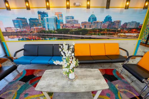 a room with a couch and a table with flowers at Philly Inn & Suites in Philadelphia