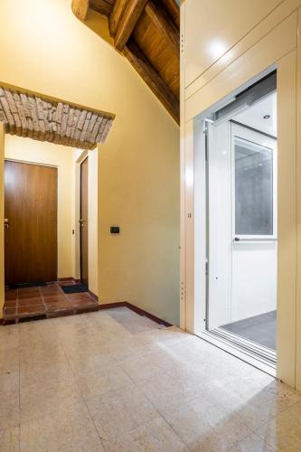 an empty hallway with a glass door in a house at CASA DUCHESSE al Castello in Ferrara