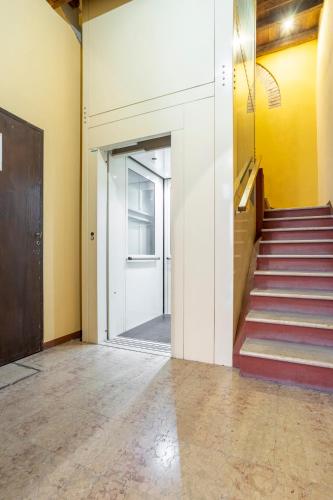a hallway with a door and stairs in a building at CASA DUCHESSE al Castello in Ferrara