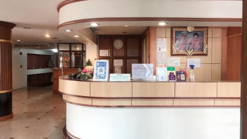 a lobby with a counter in a building at Jumbotel Hotel in Bangkok