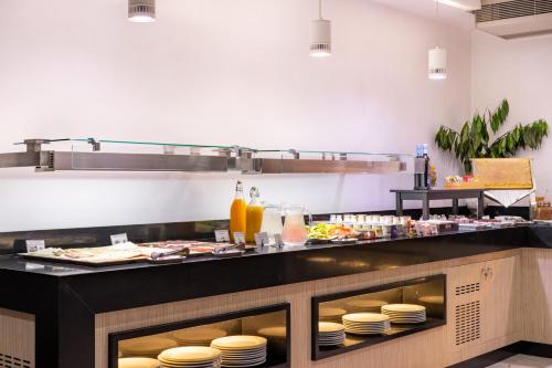 a kitchen with a buffet with plates of food at Hotel Colon Rambla in Santa Cruz de Tenerife