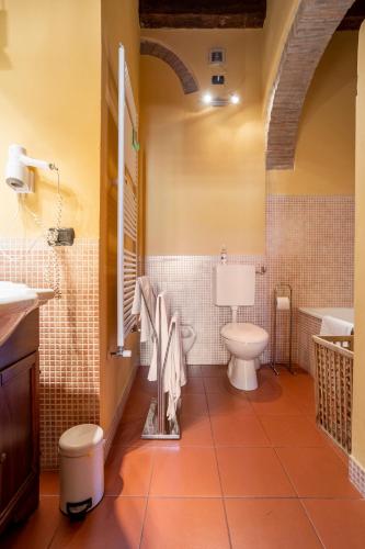 a bathroom with a toilet and a sink and a tub at CASA DUCHESSE al Castello in Ferrara